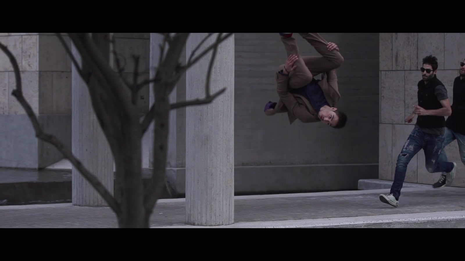 Dimitris DK Kyrsanidis performs an acrobatic move in the staged Run Away chase in Thessaloniki, Greece.