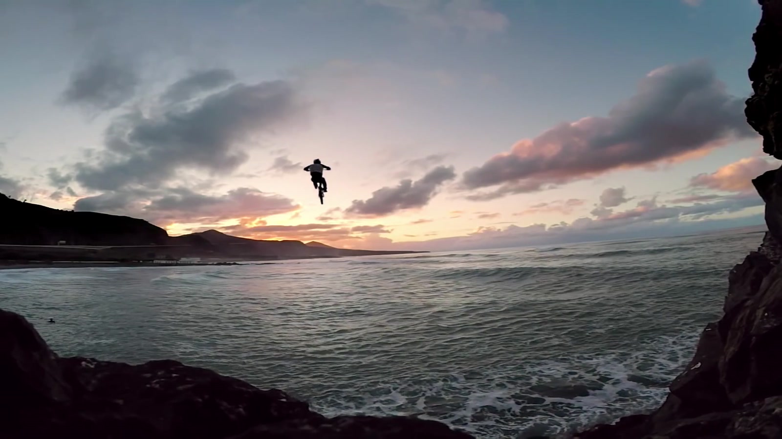 Danny MacAskill and his bicycle silhouetted in the air during the Cascadia final jump in Las Palmas, Gran Canaria, Spain.