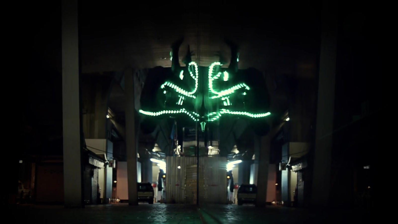 An LED-suited Team Farang freerunner creates glowing trails at night in Bangkok, Thailand.