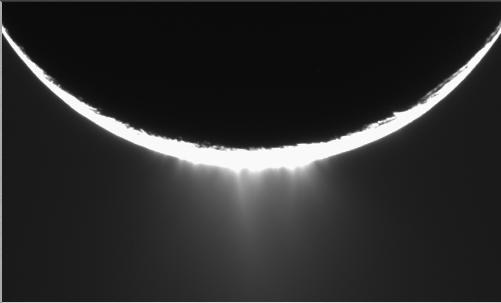 Water-ice plumes spraying from the south pole of Saturn's moon Enceladus, seen backlit