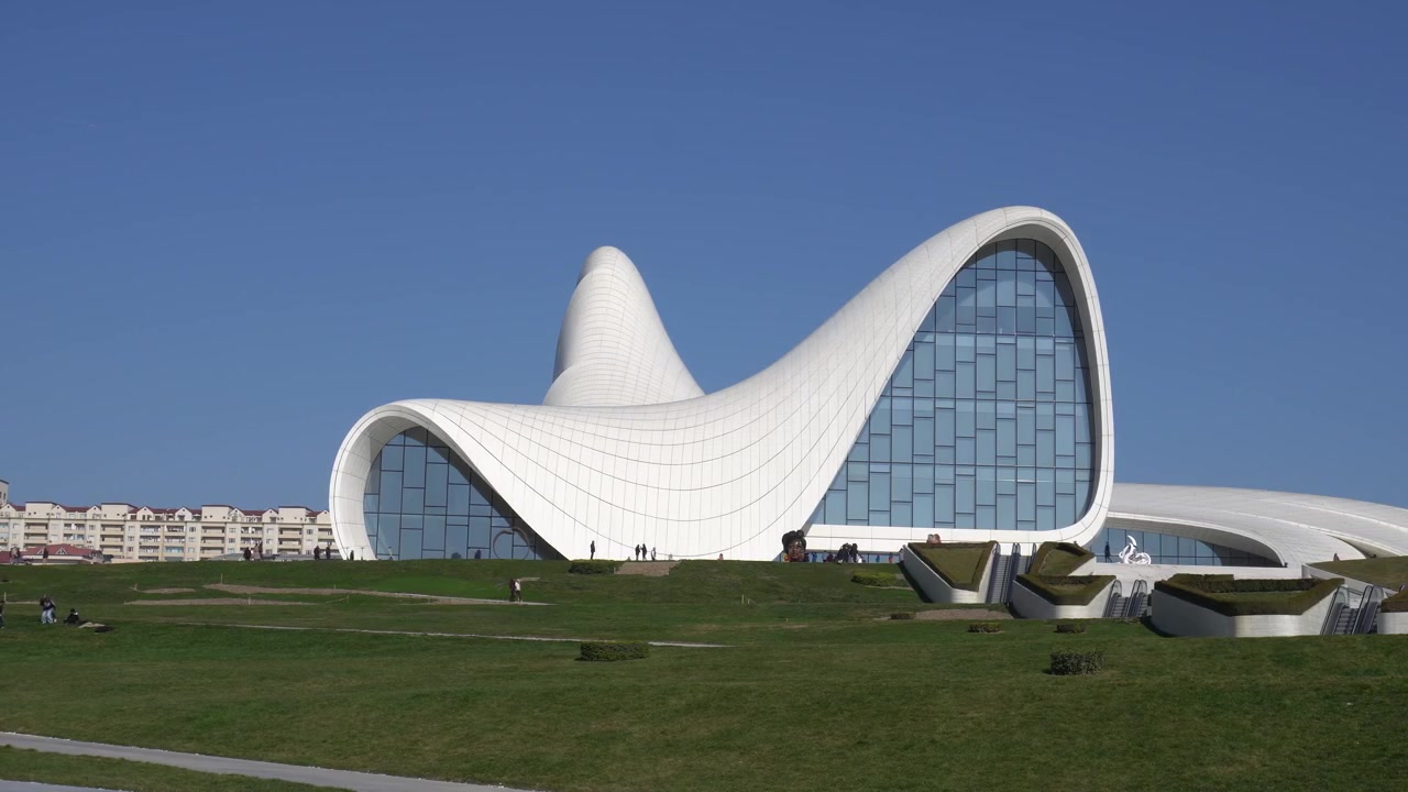 The white curved roof of the Heydar Aliyev Centre rising from its plaza in Baku