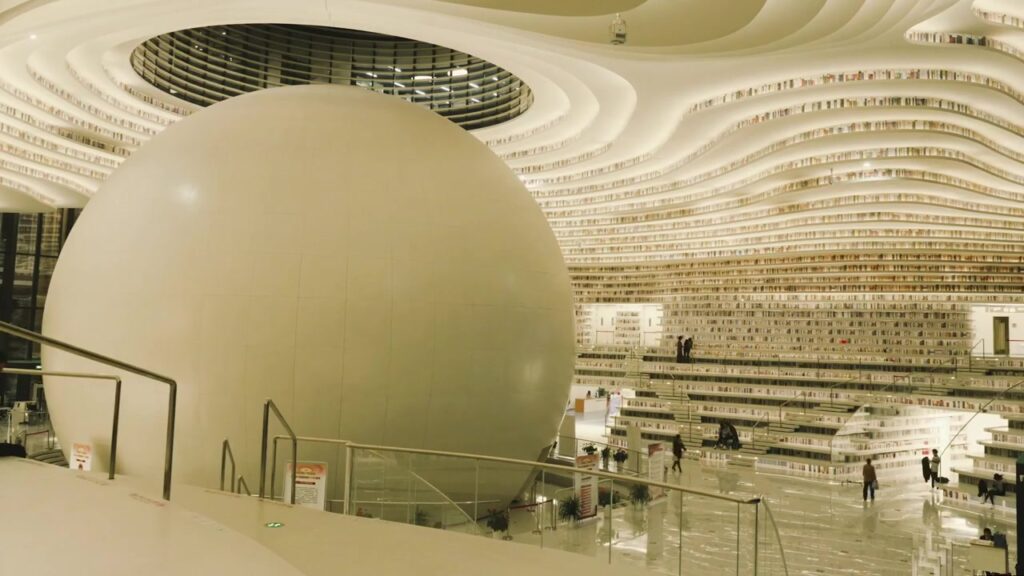 The spherical auditorium and sweeping terraced shelves inside Tianjin Binhai Library